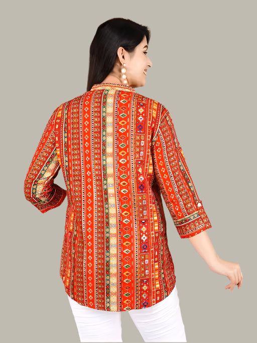 Woman wearing a red patterned blouse on a gray background